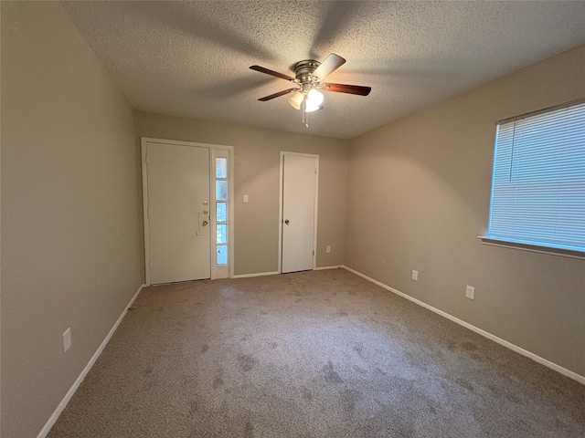 2209 Viewtop Ln Unit 2, Arlington, TX 76012 - empty room with ceiling fan, carpet, plenty of natural light, and a textured ceiling