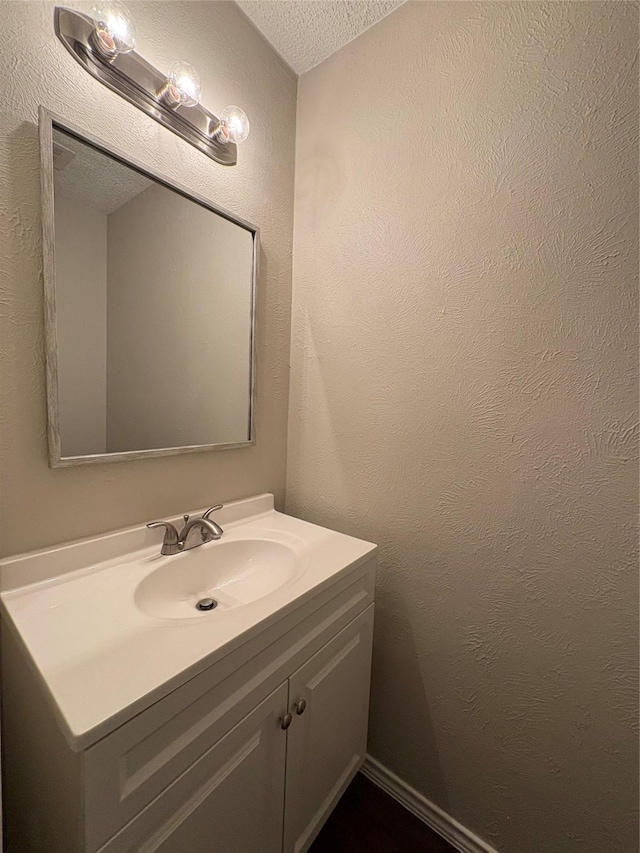 2209 Viewtop Ln Unit 2, Arlington, TX 76012 - bathroom featuring a textured ceiling, vanity, and a textured wall