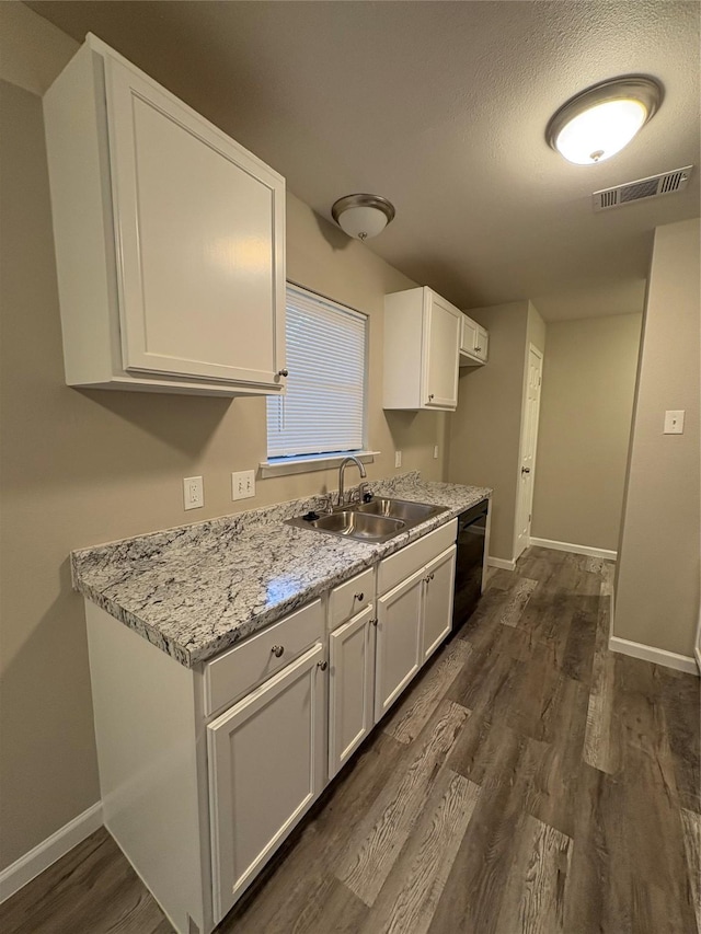2209 Viewtop Ln Unit 2, Arlington, TX 76012 - kitchen with dishwasher, dark wood-type flooring, white cabinets, and light stone countertops