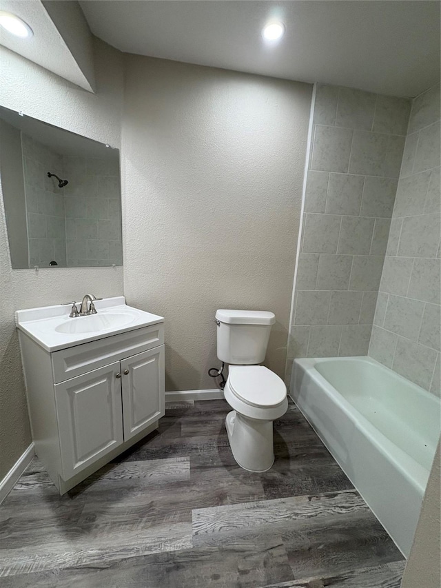 2209 Viewtop Ln Unit 2, Arlington, TX 76012 - bathroom featuring wood finished floors, vanity, tub / shower combination, recessed lighting, and a textured wall