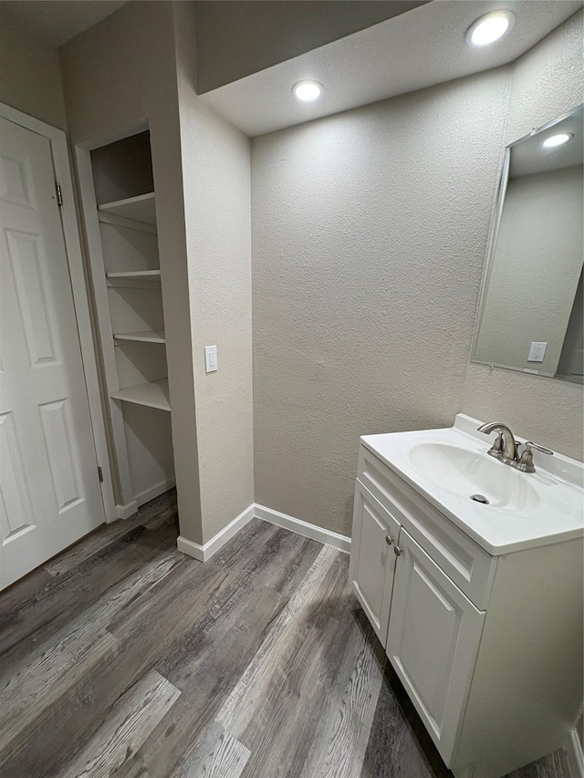 2209 Viewtop Ln Unit 2, Arlington, TX 76012 - bathroom featuring vanity, wood finished floors, a textured wall, and recessed lighting