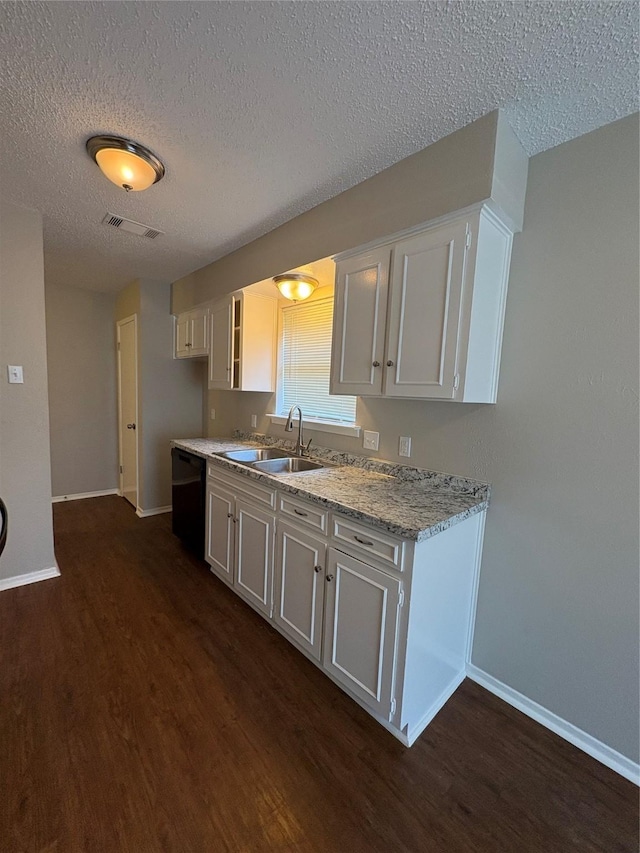 2209 Viewtop Ln Unit 2, Arlington, TX 76012 - kitchen featuring black dishwasher, dark wood-type flooring, a textured ceiling, white cabinetry, and light stone countertops
