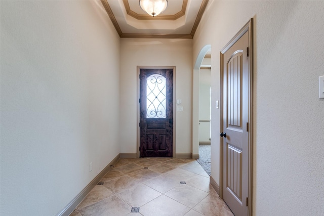 2204 Hartley Dr, Forney, TX 75126 - foyer entrance with arched walkways, ornamental molding, a tray ceiling, and light tile patterned floors