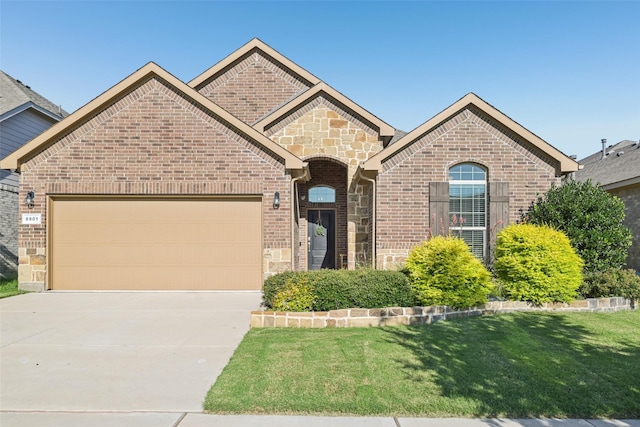 8901 Thompson Rd, Argyle, TX 76226 - french provincial home with stone siding, concrete driveway, a front yard, an attached garage, and brick siding
