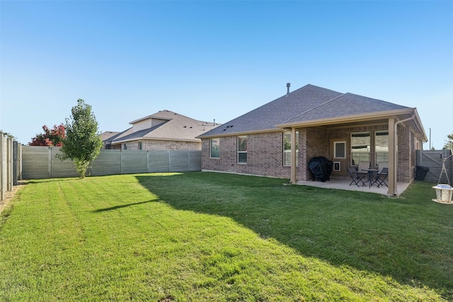 8901 Thompson Rd, Argyle, TX 76226 - rear view of house with a patio, roof with shingles, a fenced backyard, and brick siding