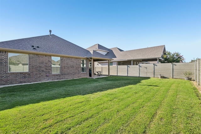 8901 Thompson Rd, Argyle, TX 76226 - rear view of property featuring a fenced backyard, a shingled roof, and brick siding