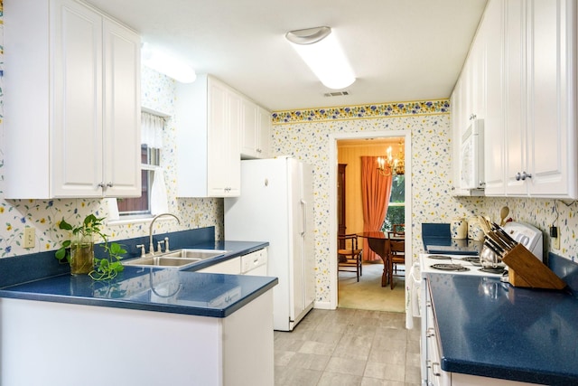 315 Ridgewood Dr, Richardson, TX 75080 - kitchen featuring white appliances, dark countertops, wallpapered walls, and plenty of natural light