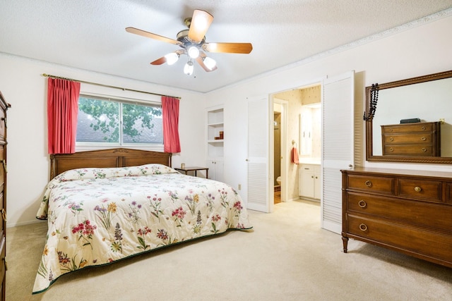 315 Ridgewood Dr, Richardson, TX 75080 - bedroom featuring light colored carpet, ensuite bath, ceiling fan, and a textured ceiling