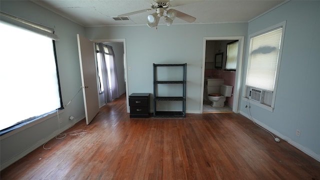 1819 Panhandle St, Denton, TX 76201 - unfurnished bedroom featuring multiple windows, crown molding, wood finished floors, and cooling unit