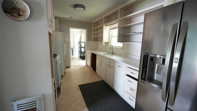1819 Panhandle St, Denton, TX 76201 - kitchen with stainless steel fridge, light flooring, open shelves, light countertops, and heating unit