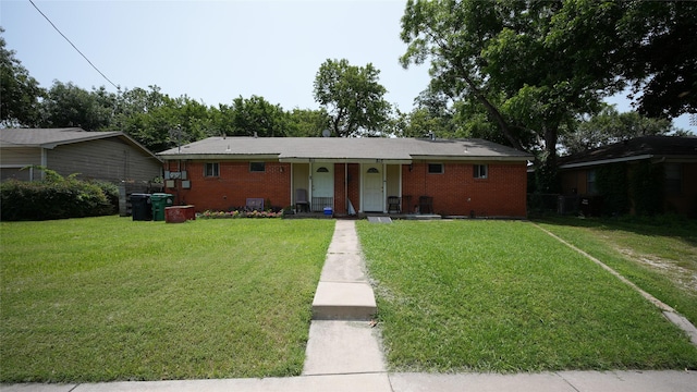 811 Crescent St, Denton, TX 76201 - view of front facade featuring covered porch, a front lawn, and brick siding