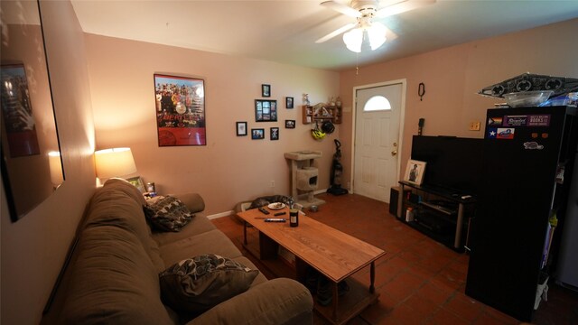 811 Crescent St, Denton, TX 76201 - living area featuring a ceiling fan and dark tile patterned flooring