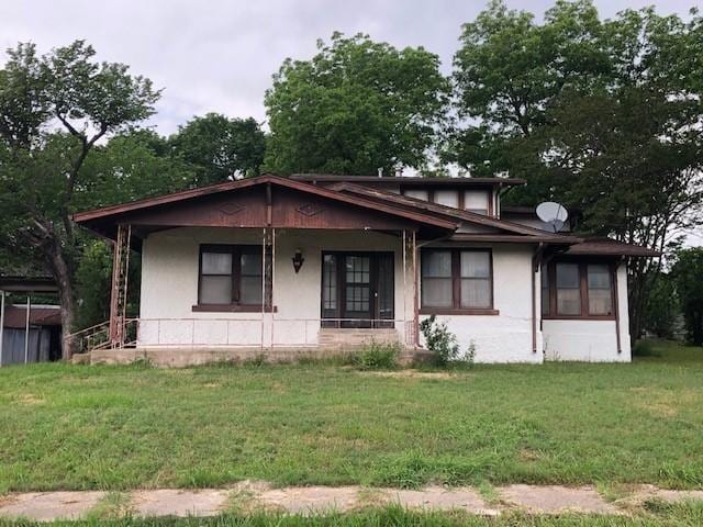 808 W 7th St, Bonham, TX 75418 - bungalow with a front lawn, a porch, and stucco siding