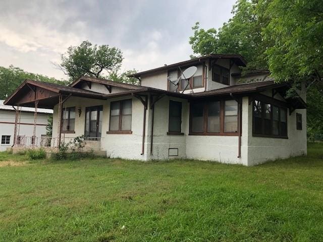 808 W 7th St, Bonham, TX 75418 - view of home's exterior featuring a yard and stucco siding