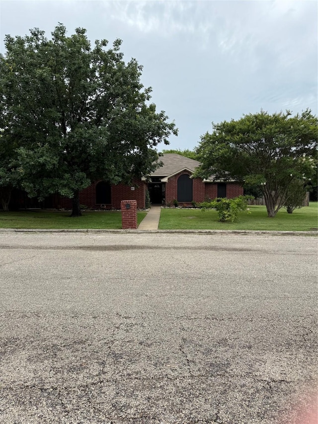 907 Dogwood St, Waco, TX 76706 - view of property hidden behind natural elements with a front lawn