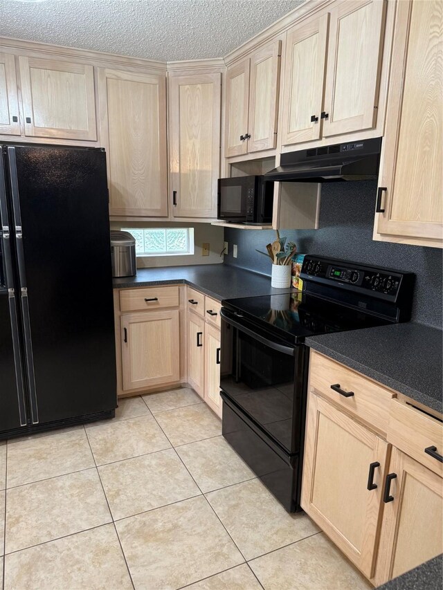 907 Dogwood St, Waco, TX 76706 - kitchen with black appliances, light brown cabinets, under cabinet range hood, dark countertops, and light tile patterned floors