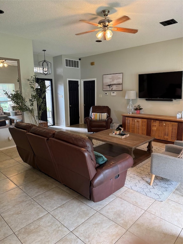 907 Dogwood St, Waco, TX 76706 - living area with ceiling fan, plenty of natural light, a textured ceiling, and light tile patterned floors