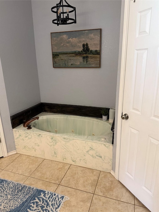 907 Dogwood St, Waco, TX 76706 - full bathroom with a jetted tub, tile patterned floors, and a chandelier