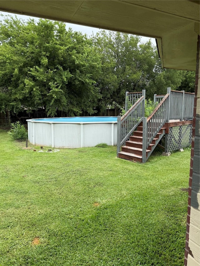 907 Dogwood St, Waco, TX 76706 - view of grassy yard featuring an outdoor pool, stairway, and a deck