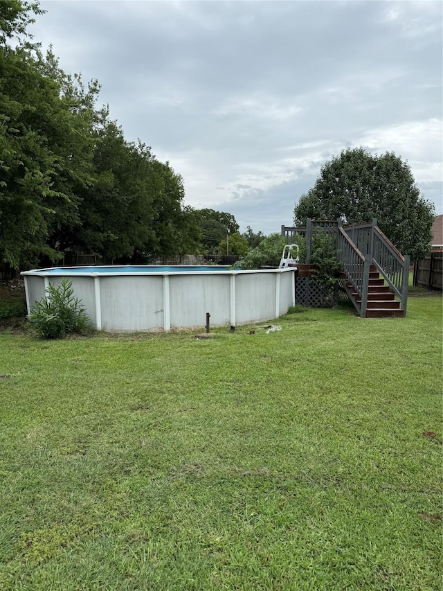 907 Dogwood St, Waco, TX 76706 - view of green lawn with stairway and an outdoor pool
