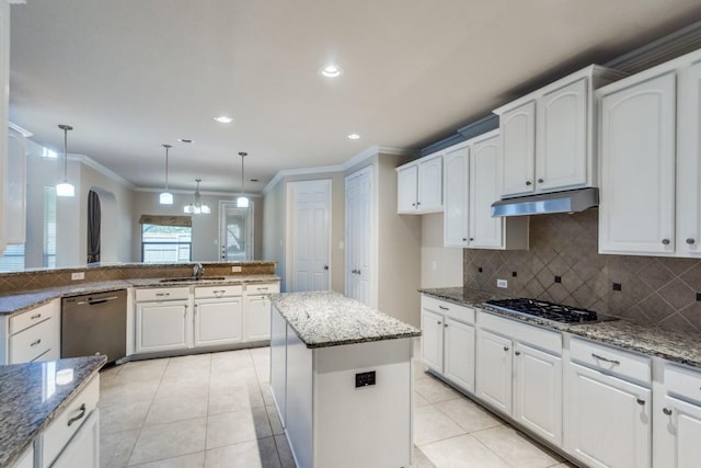 4517 Copeland Dr, Plano, TX 75024 - kitchen with stainless steel dishwasher, gas stovetop, under cabinet range hood, crown molding, and backsplash