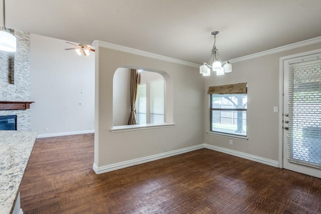 4517 Copeland Dr, Plano, TX 75024 - unfurnished dining area with a chandelier, wood finished floors, crown molding, a fireplace, and a ceiling fan