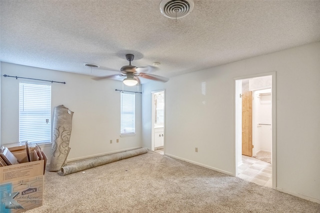 3826 Crest Way, Abilene, TX 79606 - unfurnished bedroom with light carpet, ensuite bath, a textured ceiling, and a ceiling fan