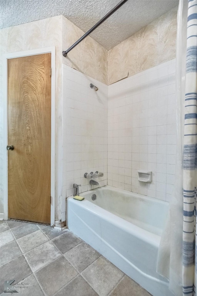 3826 Crest Way, Abilene, TX 79606 - full bathroom with shower / bath combo with shower curtain, a textured ceiling, and stone finish floors