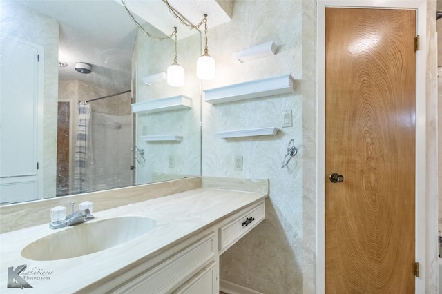 3826 Crest Way, Abilene, TX 79606 - bathroom featuring vanity, a shower, and wallpapered walls