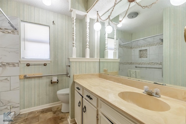 3826 Crest Way, Abilene, TX 79606 - bathroom featuring vanity, a tile shower, a textured ceiling, and wallpapered walls