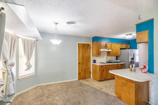 3826 Crest Way, Abilene, TX 79606 - kitchen featuring stainless steel fridge with ice dispenser, brown cabinets, light countertops, a textured ceiling, and light colored carpet