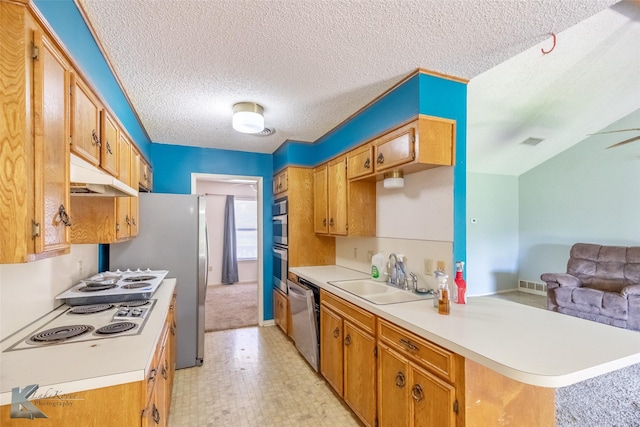 3826 Crest Way, Abilene, TX 79606 - kitchen with appliances with stainless steel finishes, a peninsula, light countertops, open floor plan, and a textured ceiling