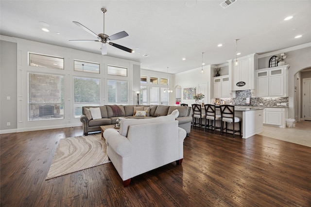 4513 Donnoli Dr, Flower Mound, TX 75022 - living area featuring a ceiling fan, arched walkways, wood finished floors, ornamental molding, and recessed lighting