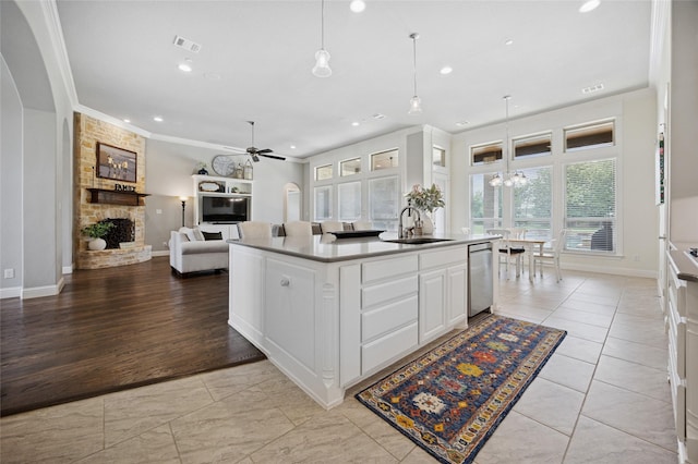 4513 Donnoli Dr, Flower Mound, TX 75022 - kitchen with a fireplace, stainless steel dishwasher, ceiling fan, recessed lighting, and ornamental molding