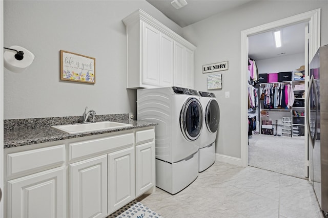 4513 Donnoli Dr, Flower Mound, TX 75022 - washroom featuring washing machine and clothes dryer, cabinet space, and light marble finish flooring