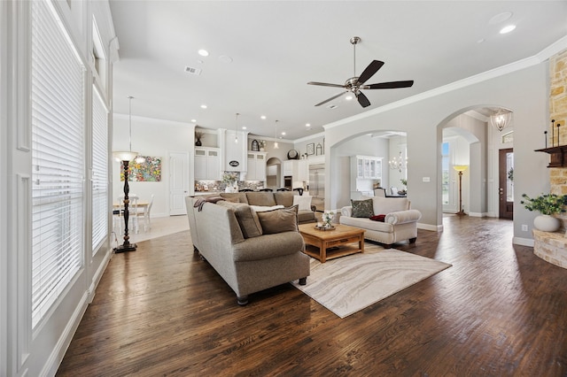 4513 Donnoli Dr, Flower Mound, TX 75022 - living room featuring a ceiling fan, ornamental molding, arched walkways, dark wood-style flooring, and recessed lighting