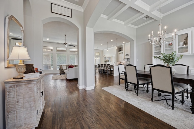 4513 Donnoli Dr, Flower Mound, TX 75022 - dining room featuring arched walkways, a ceiling fan, dark wood-style flooring, beamed ceiling, and a chandelier
