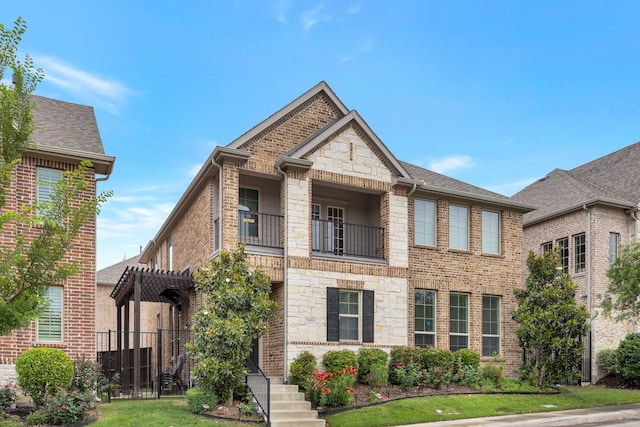 2464 Castle Ridge Dr, Richardson, TX 75080 - view of front of home with a balcony, stone siding, and brick siding