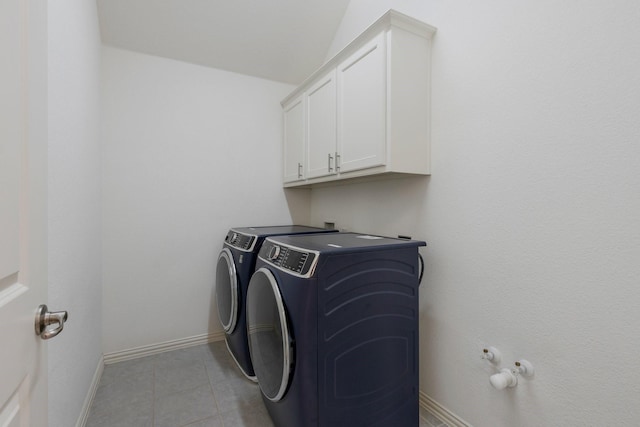 2464 Castle Ridge Dr, Richardson, TX 75080 - laundry area with washing machine and dryer, cabinet space, and light tile patterned floors