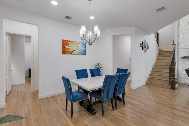2464 Castle Ridge Dr, Richardson, TX 75080 - dining area with stairs, light wood-type flooring, a chandelier, and recessed lighting