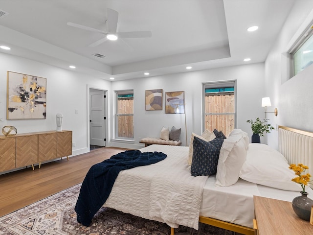 5832 Charlestown Dr, Dallas, TX 75230 - bedroom with wood finished floors, a tray ceiling, recessed lighting, and a ceiling fan