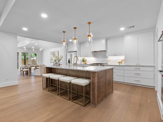 5832 Charlestown Dr, Dallas, TX 75230 - kitchen featuring light wood-style flooring, high end fridge, backsplash, light countertops, and recessed lighting