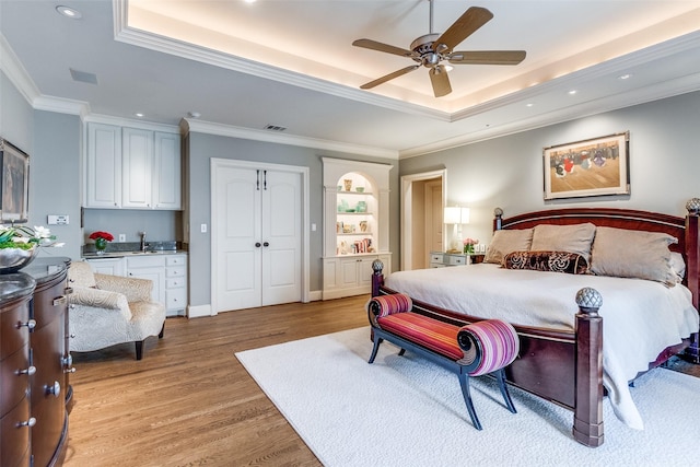 5800 Armstrong Pkwy, University Park, TX 75205 - bedroom featuring a raised ceiling, light wood-style floors, ornamental molding, recessed lighting, and a ceiling fan