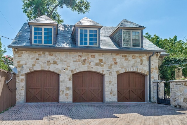 5800 Armstrong Pkwy, University Park, TX 75205 - view of front of property featuring a garage, stone siding, decorative driveway, and a high end roof