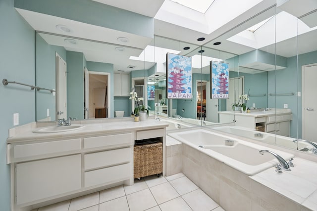240 Shady Hill Dr, Richardson, TX 75080 - bathroom with a skylight, a garden tub, vanity, and tile patterned flooring