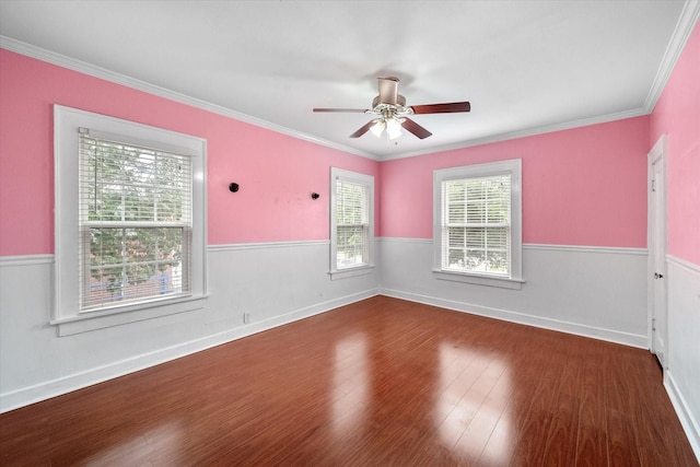 1301 W 2nd Ave, Corsicana, TX 75110 - unfurnished room featuring wood finished floors, a ceiling fan, ornamental molding, and wainscoting