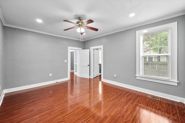 1301 W 2nd Ave, Corsicana, TX 75110 - spare room featuring a ceiling fan, wood finished floors, crown molding, and recessed lighting