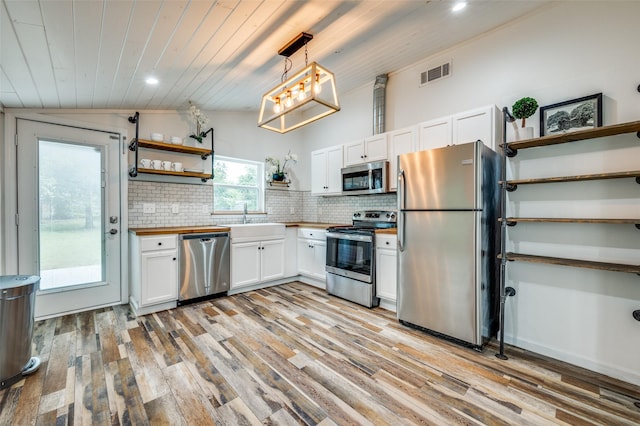 1505 W St, Mckinney, TX 75069 - kitchen featuring appliances with stainless steel finishes, open shelves, light wood-style floors, white cabinets, and wood ceiling
