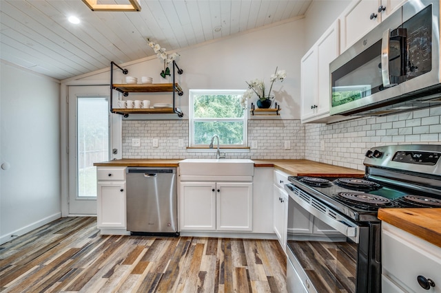 1505 W St, Mckinney, TX 75069 - kitchen with butcher block counters, stainless steel appliances, lofted ceiling, open shelves, and wooden ceiling