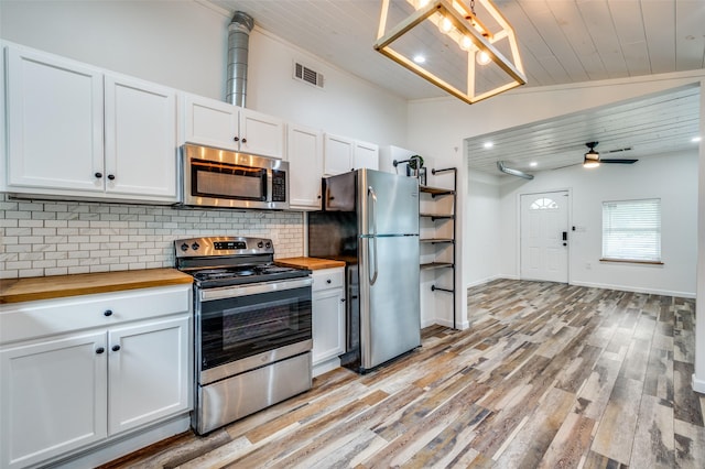 1505 W St, Mckinney, TX 75069 - kitchen featuring appliances with stainless steel finishes, butcher block counters, backsplash, light wood-style floors, and white cabinets